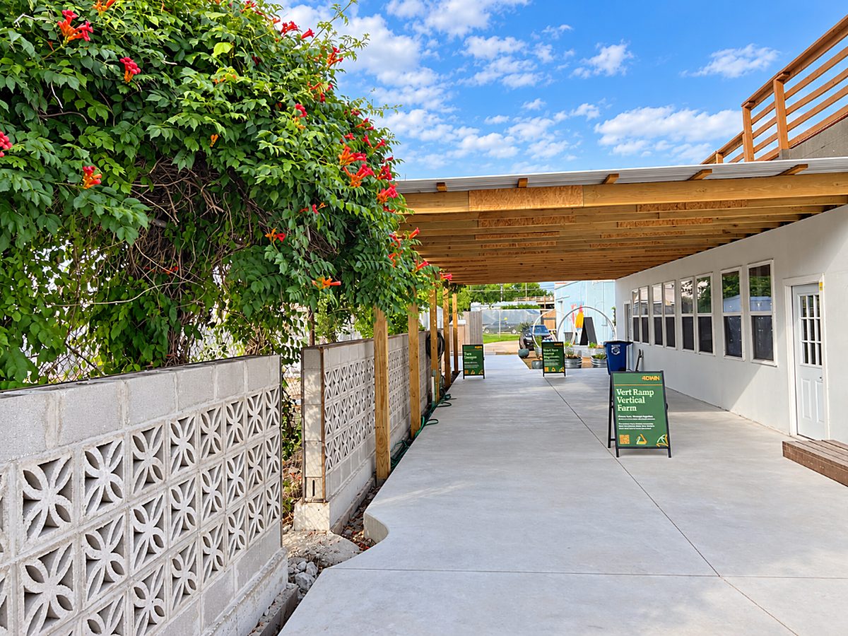 Covered walkway with vertical farm and compost signs